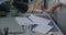 Close-up of female hands tidying desk holding books and stationery objects cleaning apartment