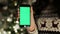 Close-up of female hands touching of smartphone. Green screen Chroma Key. Close up. Tracking motion. with blur christmas