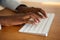 Close up female hands typing on computer keyboard