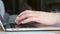 Close up of female hands typing on modern laptop keyboard making notes writing on device