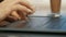 Close-up of female hands using touchpad and surfing internet, modern student works on a laptop