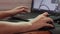 Close up of female hands working simultaneously with a mouse and stylus on a laptop