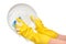 Close up of female hands in yellow protective rubber gloves washing white plate with blue cleaning sponge