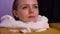 Close-up of a female head peeking out of a hot barrel. Woman in a cedar barrel in a spa salon. The blonde is undergoing