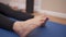 Close up female her foot, rotating ankle warming up, bone and joint stretching, sit down on exercise mat on floor, twisting ankle,