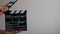 Close up female hold in hand wooden director clear empty black film making clapperboard isolated on gray background