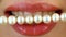 Close up of female lips and pearl bead. Dental concept.