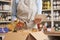 Close Up Of Female Owner Of Delicatessen Food Shop With Digital Tablet Preparing Online Grocery Order