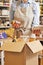 Close Up Of Female Owner Of Delicatessen Food Shop With Digital Tablet Preparing Online Grocery Order