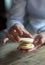 Close up of female pastry chef\'s hand cooking delicious macaroon