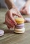 Close up of female pastry chef\'s hand cooking delicious macaroon