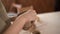 Close-up female potter's hand sculpting a clay pot with her hands. Woman ceramist works with raw earthenware