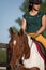 Close up of female rider on palomino mare.