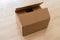 close-up of female sealing cardboard box with adhesive tape