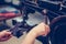 Close up of a female shoemaker hands stitching a part of the shoe