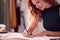 Close Up Of Female Student Or Business Owner Working In Fashion Sketching Designs In Studio