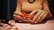 Close-up Female tearing heart valentines card in her hands