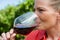 Close-up of female vintner tasting glass of wine