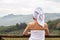 Close up of female wearing white towel around her body with wet hair wrapped with towel enjoying amazing view of Toscana hills