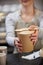 Close Up Of Female Worker in Cafe Serving Meal In Sustainable Recyclable Packaging With Wooden Spoon