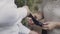 Close-up of females hands with manicured nails adjusting black tie of beloved businessman in suit. Affectionate woman