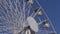 Close up of ferris wheel on street fair over blue sky