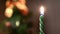 Close-up of festive candle on background of blurred lights. Concept. Clear focus on candle holder burning on background