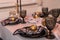 Close up of festive Christmas table setting with empty wine glasses and black plate with gold garnet