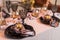 Close up of festive Christmas table setting with empty wine glasses and black plate with gold garnet