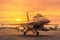 Close up fighter jet military aircraft parked on runway on sunset