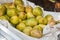 Close up. Figs fruit. Yellow ripe juicy fruits sold in a box