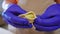 Close-up filling dumpling dough with potato ball in slow motion. Front view unrecognizable Caucasian woman in gloves