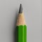 close-up of a finely sharpened green pencil on a gray background. Generative Ai