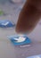 Close up of finger choosing twitter icon