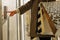 Close-up of a finger presses the elevator button. a woman with shopping bags in a beige raincoat calls the elevator