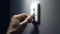 Close up of finger turn off on light switch at the wall. Energy saving concept. Selected focus