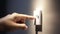 Close up of finger turn off on light switch at the wall. Energy saving concept. Selected focus