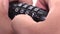 Close-up of fingers closing a combination lock on a white background