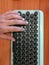 Close up of fingers pressing buttons on a teal computer keyboard