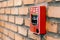 Close up fire alarm activation box on brick wall in room