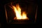 Close-up of fire in lit wood pellet stove