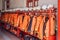 Close up of Fireman coats, helmets and boots wait for the next call. Dressing room of the volunteer fire department