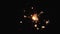 Close-up of firework sparkler burning. Fireworks burn on a black background. Slow motion shot