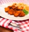 Close up of fish and chips with peas and a slice of lemon