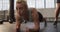 Close up of fit caucasian woman performing plank exercise at the gym