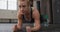 Close up of fit caucasian woman performing plank exercise at the gym