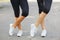 Close-up fit legs in sportswear on a blurred background. Girls in sneakers. Runner concept.