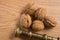 Close up of five walnuts and a nutcracker