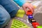 Close-up of five year old boy playing and lining up toy cars holding a red pickup truck