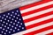 Close up flag of USA on wooden background.